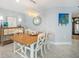 Dining room area features a stylish light fixture and adjacent credenza for storage at 6470 Mourning Dove Dr # 201, Bradenton, FL 34210