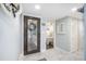 The welcoming entryway features tile flooring, a decorative glass door, and access to a bedroom at 6470 Mourning Dove Dr # 201, Bradenton, FL 34210