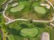 Close up aerial view of golf course with many different greens and trees at 6470 Mourning Dove Dr # 201, Bradenton, FL 34210