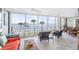 Bright living room featuring floor to ceiling windows with ocean views and access to the balcony at 6470 Mourning Dove Dr # 201, Bradenton, FL 34210