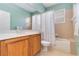 Bright bathroom featuring a bathtub, wood cabinets, and a large mirror above the sink at 6519 43Rd E Ct, Sarasota, FL 34243