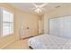 Comfortable bedroom with tiled floors, a floral bed set, and a large closet at 6519 43Rd E Ct, Sarasota, FL 34243