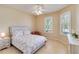 Bright bedroom with tiled floors featuring a floral bed set and two windows at 6519 43Rd E Ct, Sarasota, FL 34243