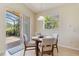 Bright breakfast nook with tiled floors features outdoor views and a modern light fixture at 6519 43Rd E Ct, Sarasota, FL 34243