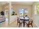 Breakfast nook with seating for four offers serene outdoor views of the community at 6519 43Rd E Ct, Sarasota, FL 34243