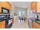 Open kitchen with breakfast nook featuring wood cabinets, black appliances, and outdoor views at 6519 43Rd E Ct, Sarasota, FL 34243