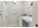 Well-equipped laundry room with a modern washer and dryer set and convenient storage shelves at 6519 43Rd E Ct, Sarasota, FL 34243