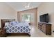 Cozy main bedroom with a bay window, ceiling fan, and tiled floors at 6519 43Rd E Ct, Sarasota, FL 34243