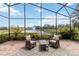 Screened lanai featuring seating area with lovely views of the pond with fountain at 6519 43Rd E Ct, Sarasota, FL 34243