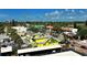 Beautiful aerial view of a town with colorful buildings, green trees, and a glimpse of the ocean at 6610 Midnight Pass Rd # 11, Sarasota, FL 34242