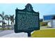 Siesta Public Beach information sign detailing history, surrounded by palm trees and sidewalk at 6610 Midnight Pass Rd # 11, Sarasota, FL 34242