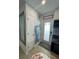 Charming entryway with coastal decor, including a mermaid tail and Siesta Key sign, next to a door and mirror at 6610 Midnight Pass Rd # 11, Sarasota, FL 34242