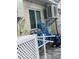 Exterior patio of the home featuring a window, foliage mural, and beach supplies, along with AC units at 6610 Midnight Pass Rd # 11, Sarasota, FL 34242
