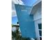Close up view of property's bright blue exterior with white lettering at 6610 Midnight Pass Rd # 11, Sarasota, FL 34242