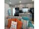 Coastal-themed living room with kitchen view, comfortable seating, and natural light at 6610 Midnight Pass Rd # 11, Sarasota, FL 34242
