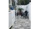 Private patio area with patio furniture and a small palm tree, perfect for outdoor relaxing at 6610 Midnight Pass Rd # 11, Sarasota, FL 34242