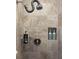 Updated shower with a gray tile surround, modern fixtures, and convenient storage niche at 6610 Midnight Pass Rd # 11, Sarasota, FL 34242