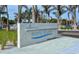 Contemporary Siesta Beach sign with sleek design and landscaping by the roadway at 6610 Midnight Pass Rd # 11, Sarasota, FL 34242