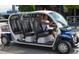 Siesta Key Free Ride taxi cart with open seating for passengers and the driver wearing sunglasses at 6610 Midnight Pass Rd # 11, Sarasota, FL 34242