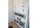 A linen closet is well-organized with soft towels, beach decor, and ample storage space at 6610 Midnight Pass Rd # 11, Sarasota, FL 34242
