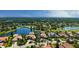 Beautiful lakefront estate featuring a luxurious home with a pool and a scenic golf course backdrop at 6819 Dominion Ln, Lakewood Ranch, FL 34202