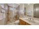 Well-lit bathroom with a glass shower, neutral tile, and coordinated fixtures and towel display at 6819 Dominion Ln, Lakewood Ranch, FL 34202