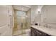 Bathroom boasts modern fixtures, glass shower, and a vanity with a white countertop and dark cabinets at 6819 Dominion Ln, Lakewood Ranch, FL 34202