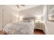 Well-lit bedroom featuring hardwood floors, neutral walls, and a comfortable queen-size bed at 6819 Dominion Ln, Lakewood Ranch, FL 34202
