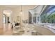 Bright dining area featuring a glass table and poolside view, perfect for enjoying meals with a view at 6819 Dominion Ln, Lakewood Ranch, FL 34202