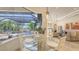 A spacious dining area overlooks the pool, offering a relaxed atmosphere for Gathering meals at 6819 Dominion Ln, Lakewood Ranch, FL 34202