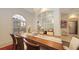 Bright dining room with wooden table, stylish chairs, and large windows at 6819 Dominion Ln, Lakewood Ranch, FL 34202