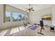 Bright home gym features large windows, ceiling fan, workout equipment, and tiled floors at 6819 Dominion Ln, Lakewood Ranch, FL 34202