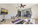 Well-lit home gym offers a ceiling fan, sliding glass doors, and assorted workout equipment at 6819 Dominion Ln, Lakewood Ranch, FL 34202