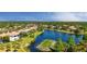 Charming two-story home featuring a tile roof, lush landscaping, and stunning lake and golf course views at 6819 Dominion Ln, Lakewood Ranch, FL 34202