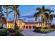 Elegant home featuring lush landscaping, a paver driveway, and a three-car garage at 6819 Dominion Ln, Lakewood Ranch, FL 34202