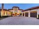 Elegant two-story home featuring a paver driveway, a tile roof, and a three-car garage at 6819 Dominion Ln, Lakewood Ranch, FL 34202