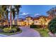 Stunning curb appeal with a paver driveway, beautiful landscaping, and a warm, inviting facade at 6819 Dominion Ln, Lakewood Ranch, FL 34202