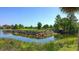 Picturesque golf course features a water hazard with rock retaining walls and lush green landscaping at 6819 Dominion Ln, Lakewood Ranch, FL 34202