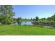 Beautiful golf course view features a tranquil lake, vibrant green grass, and scenic landscaping at 6819 Dominion Ln, Lakewood Ranch, FL 34202