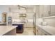 Bright and modern kitchen boasts stainless steel appliances, stone countertops, and white custom cabinetry at 6819 Dominion Ln, Lakewood Ranch, FL 34202