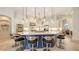 Spacious kitchen boasts large island, stainless appliances, white cabinets, and stylish pendant lighting at 6819 Dominion Ln, Lakewood Ranch, FL 34202