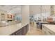Open concept kitchen with modern island, stone countertops, and seamless flow to the living and dining areas at 6819 Dominion Ln, Lakewood Ranch, FL 34202