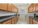 Laundry room featuring wooden cabinets, granite countertops, and modern washer and dryer at 6819 Dominion Ln, Lakewood Ranch, FL 34202