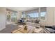 Bright living room featuring large windows, comfortable seating, and a workspace overlooking a screened-in patio at 6819 Dominion Ln, Lakewood Ranch, FL 34202