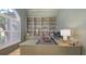 Home office with built in shelving units and large desk at 6819 Dominion Ln, Lakewood Ranch, FL 34202