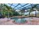 Screened in pool area featuring tropical landscaping, a pool, and jacuzzi at 6819 Dominion Ln, Lakewood Ranch, FL 34202