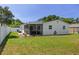 Spacious backyard showcasing a screened-in porch and well-kept lawn at 7141 37Th N Ave, St Petersburg, FL 33710