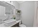 Modern bathroom featuring a vessel sink, stylish mosaic tile accent, and floating shelves with plants at 7141 37Th N Ave, St Petersburg, FL 33710
