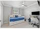 Bright bedroom featuring a daybed with storage and a dedicated workspace with a large monitor at 7141 37Th N Ave, St Petersburg, FL 33710