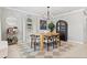 Stylishly decorated dining room featuring modern lighting and decor adjacent to an open concept kitchen at 7141 37Th N Ave, St Petersburg, FL 33710